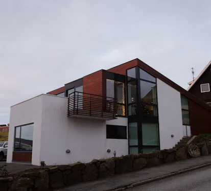exterior residential two-story home with gray stucco finish